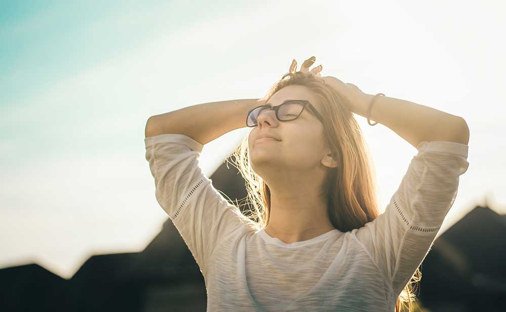 Woman  soaking in the sun while she experiences a pain-free day
