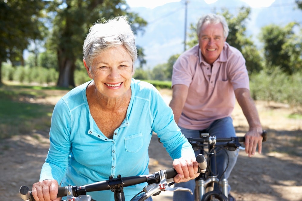 A couple enjoy riding their bikes together after SUPARTZ Therapy
