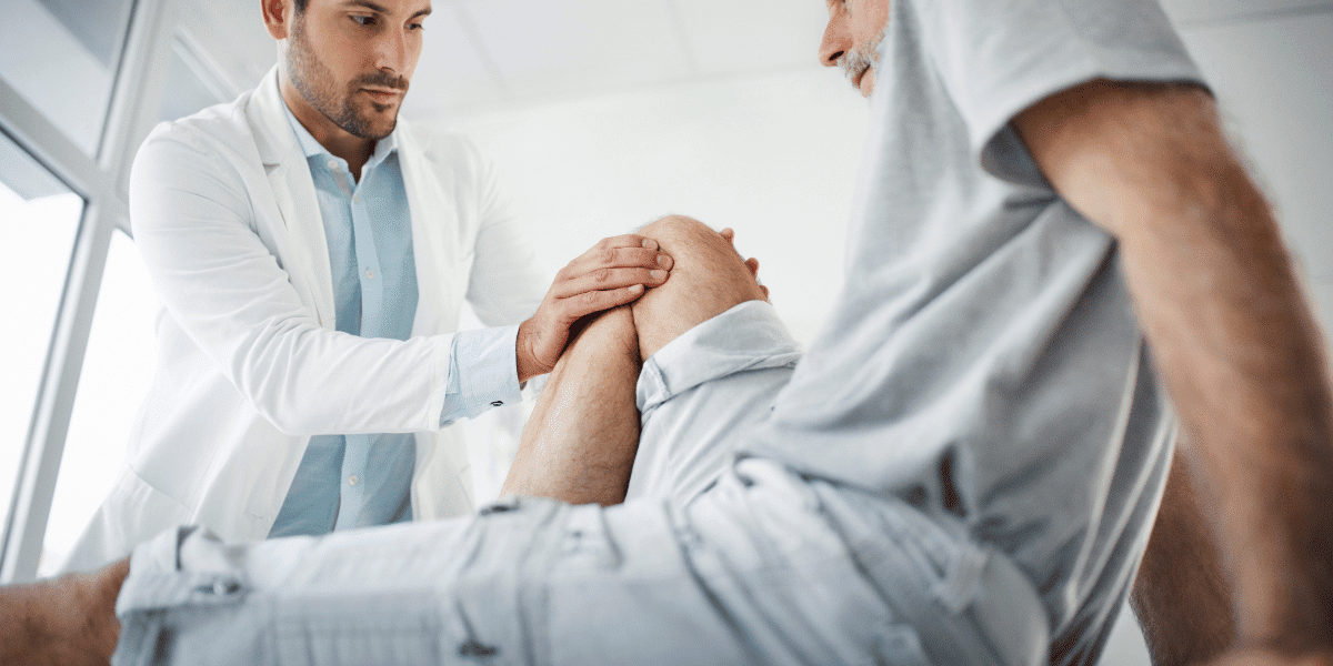 A doctor engaging in a consultation with a patient struggling with knee pain