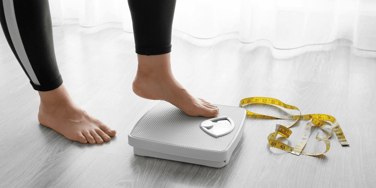 A person stepping on a scale to check their weight