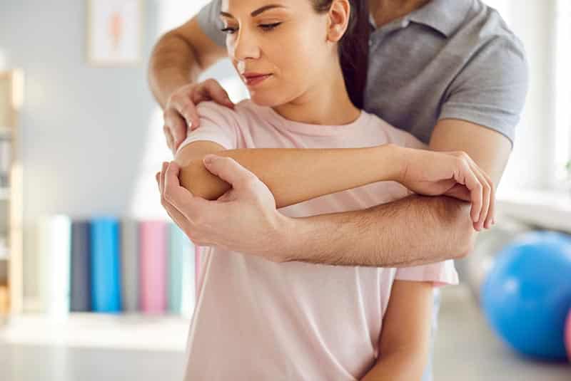 A female patient receives the Active Release Technique from one of our chiropractors