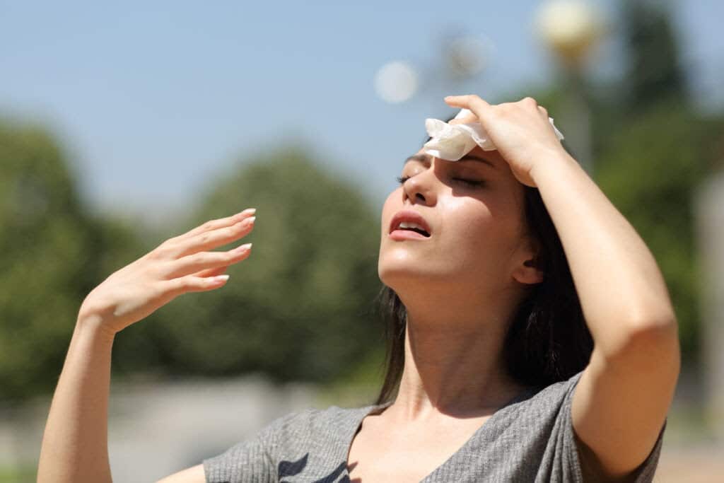 A woman drying sweat in a warm summer day.